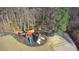 Large backyard with wooden playground, trampoline, and volleyball court for endless outdoor activities at 3499 Lake Mill Rd, Buford, GA 30519