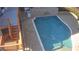 Backyard pool with a tanning ledge, surrounding patio, and stairs leading to deck, perfect for outdoor enjoyment at 3499 Lake Mill Rd, Buford, GA 30519