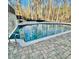 Large inground pool surrounded by stone patio and lush landscaping at 3499 Lake Mill Rd, Buford, GA 30519