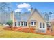 Home's exterior view showcasing patio, landscaped backyard, and architectural details at 221 The Esplanade Se Way, Loganville, GA 30052