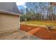 Backyard patio area with brick path, bird bath, and view of a tree-lined yard at 221 The Esplanade Se Way, Loganville, GA 30052