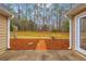 Backyard patio area with brick path, bird bath, and view of a tree-lined yard at 221 The Esplanade Se Way, Loganville, GA 30052