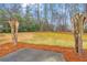 Backyard patio area with mature trees and well-maintained lawn at 221 The Esplanade Se Way, Loganville, GA 30052