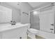 Well-lit bathroom featuring a combination shower and bathtub at 221 The Esplanade Se Way, Loganville, GA 30052