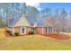 Welcoming front exterior featuring a brick facade, well-maintained lawn, trimmed bushes, and a cozy entrance at 221 The Esplanade Se Way, Loganville, GA 30052