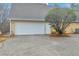 Attached garage featuring a double door, concrete driveway, well-kept lawn, and a side entrance at 221 The Esplanade Se Way, Loganville, GA 30052