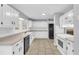 Bright kitchen featuring granite countertops, white cabinets, and stainless steel appliances at 221 The Esplanade Se Way, Loganville, GA 30052