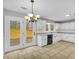 Well-lit kitchen area featuring stainless steel appliances, white cabinets, and a view of the backyard at 221 The Esplanade Se Way, Loganville, GA 30052