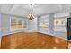 Open-concept living and dining room featuring hardwood floors, modern lighting, and a view of the backyard at 221 The Esplanade Se Way, Loganville, GA 30052