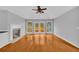 Well-lit living room with hardwood floors, fireplace, and large windows overlooking the backyard at 221 The Esplanade Se Way, Loganville, GA 30052