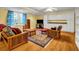 Basement area with hardwood floors, a futon, area rug, and white storage cabinets at 3369 Arbor Path Dr, Atlanta, GA 30340