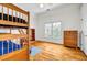 Spacious bedroom with hardwood floors, bunk bed, and a window offering natural light at 3369 Arbor Path Dr, Atlanta, GA 30340