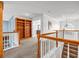 Bright hallway featuring a staircase, built-in wooden bookcase, and arched window at 3369 Arbor Path Dr, Atlanta, GA 30340