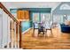 A dining table area connected to the kitchen with hardwood floors and large windows at 3369 Arbor Path Drive Dr, Atlanta, GA 30340