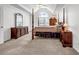 Elegant main bedroom featuring a four-poster bed, tray ceiling, and ample natural light at 3369 Arbor Path Dr, Atlanta, GA 30340