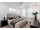 Bright bedroom featuring a plush bed with decorative pillows, complemented by modern nightstands and a ceiling fan at 388 Pratt Se Dr # 2134, Atlanta, GA 30315