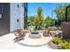 Outdoor fire pit area with Adirondack chairs, stone pavers, and lush landscaping at 388 Pratt Se Dr # 2134, Atlanta, GA 30315