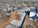 Aerial view of backyard with a large parking pad, storage shed, gray exterior and fenced perimeter at 449 South Hill St., Buford, GA 30518