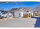 Gray home with an expansive backyard with a concrete patio, showcasing a back entrance and tidy landscaping at 449 South Hill St., Buford, GA 30518