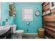 Charming bathroom with turquoise walls, wood accents, and modern fixtures at 449 South Hill St., Buford, GA 30518