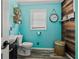 Charming bathroom with turquoise walls, wood accents, and modern fixtures at 449 South Hill St., Buford, GA 30518