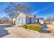 Charming one-story home with light-colored siding, a blue door, and manicured landscaping, creating inviting curb appeal at 449 South Hill St., Buford, GA 30518