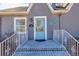 A close up of the front porch and turquoise blue door of the home at 449 South Hill St., Buford, GA 30518