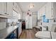 Bright kitchen featuring white cabinets, hardwood floors, and stainless refrigerator at 449 South Hill St., Buford, GA 30518