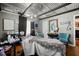 Room view with corrugated tin ceiling, grey walls, and pops of color and art throughout the space at 449 South Hill St., Buford, GA 30518