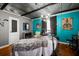 A tin ceiling room with grey and turquoise walls, art, ample space, and unique accents at 449 South Hill St., Buford, GA 30518