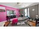 An eclectic room features striped walls, bright pink accents, and unique decor, creating a bold and modern aesthetic at 449 South Hill St., Buford, GA 30518