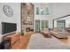 Spacious living room featuring a stone fireplace, hardwood floors, and ample natural light at 718 Fincher Rd, Covington, GA 30016