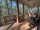 Spacious covered porch with a view of the surrounding woods, perfect for outdoor relaxation at 718 Fincher Rd, Covington, GA 30016