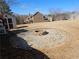 Spacious backyard features a stone fire pit, shed, and ample space for outdoor activities at 209 Crestmont Way, Canton, GA 30114