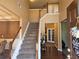 Welcoming foyer with a staircase, hardwood floors, and an open view to other rooms at 209 Crestmont Way, Canton, GA 30114