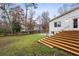 Spacious backyard features mature trees, a wooden deck, and a lush green lawn at 2508 Brookwood Ne Dr, Atlanta, GA 30305
