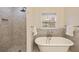 Serene bathroom boasts a soaking tub, separate shower, and refined finishes, creating a spa-like experience at 2508 Brookwood Ne Dr, Atlanta, GA 30305