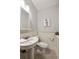 Charming half-bathroom featuring pedestal sink, white wainscoting and herringbone tile floor at 2508 Brookwood Ne Dr, Atlanta, GA 30305