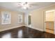 A bright bedroom boasts hardwood floors, two windows, and an ensuite bathroom and walk-in closet at 2508 Brookwood Ne Dr, Atlanta, GA 30305