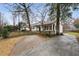 Long driveway leading to the home with brickwork, complemented by mature trees and landscaping at 2508 Brookwood Ne Dr, Atlanta, GA 30305