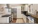 Well-equipped kitchen with stainless appliances, ample white cabinetry, granite countertops, and designer backsplash at 2508 Brookwood Ne Dr, Atlanta, GA 30305