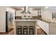 Well-lit kitchen with stainless steel appliances, white cabinetry, and an island with bar stool seating at 2508 Brookwood Ne Dr, Atlanta, GA 30305