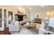 Spacious living room features a cozy fireplace, neutral decor, large windows, and access to outdoor spaces at 2508 Brookwood Ne Dr, Atlanta, GA 30305