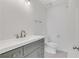 This bathroom has a gray vanity with white countertop, brushed nickel faucet, and tiled floors at 2964 Hollow Ln, Powder Springs, GA 30127