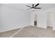 This bedroom features neutral carpeting, white walls, and a ceiling fan, and access to an ensuite bathroom and closet at 2964 Hollow Ln, Powder Springs, GA 30127