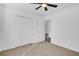 Bedroom with ceiling fan, plush carpet, and closet storage at 2964 Hollow Ln, Powder Springs, GA 30127