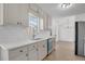 Updated kitchen featuring white cabinets, quartz counters, stainless appliances, and natural light at 2964 Hollow Ln, Powder Springs, GA 30127
