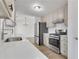 Bright kitchen featuring stainless steel appliances, white cabinets, and quartz countertops at 2964 Hollow Ln, Powder Springs, GA 30127