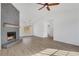 Cozy living room featuring a stone fireplace, vaulted ceilings, and hardwood floors at 2964 Hollow Ln, Powder Springs, GA 30127