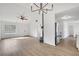 Open-concept living area featuring hardwood floors, modern lighting, and access to kitchen at 2964 Hollow Ln, Powder Springs, GA 30127